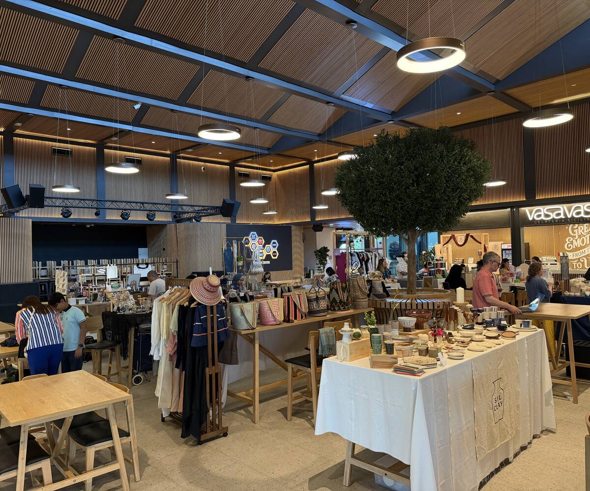 Artisan stalls with handmade pottery, woven bags and clothing in the Flavours Hub hall